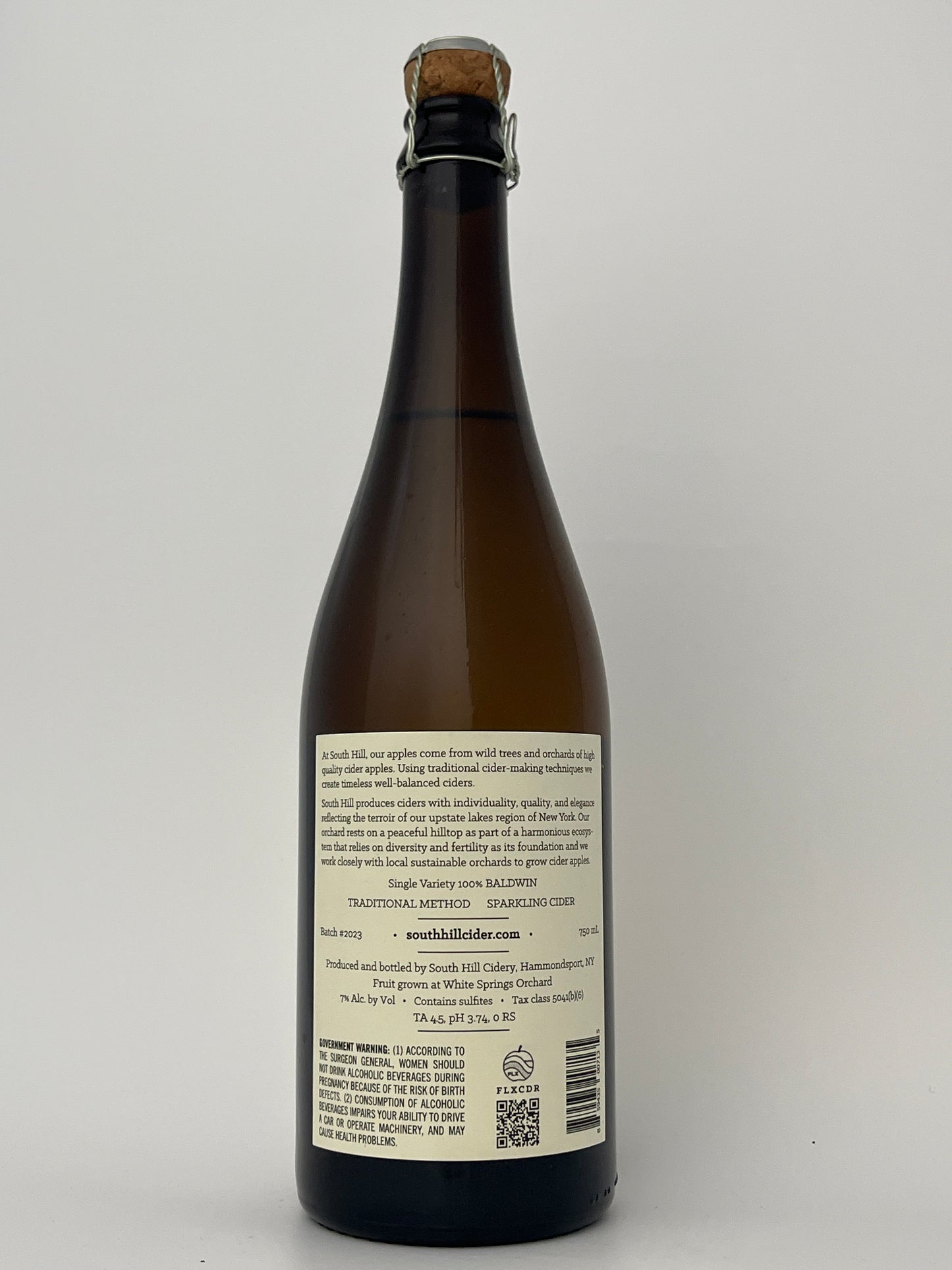 Back label of a bottle of South Hill Cider Baldwin in a white backround.