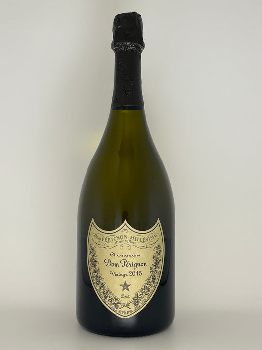 Bottle of Dom Pérignon 2015 champagne on a white background