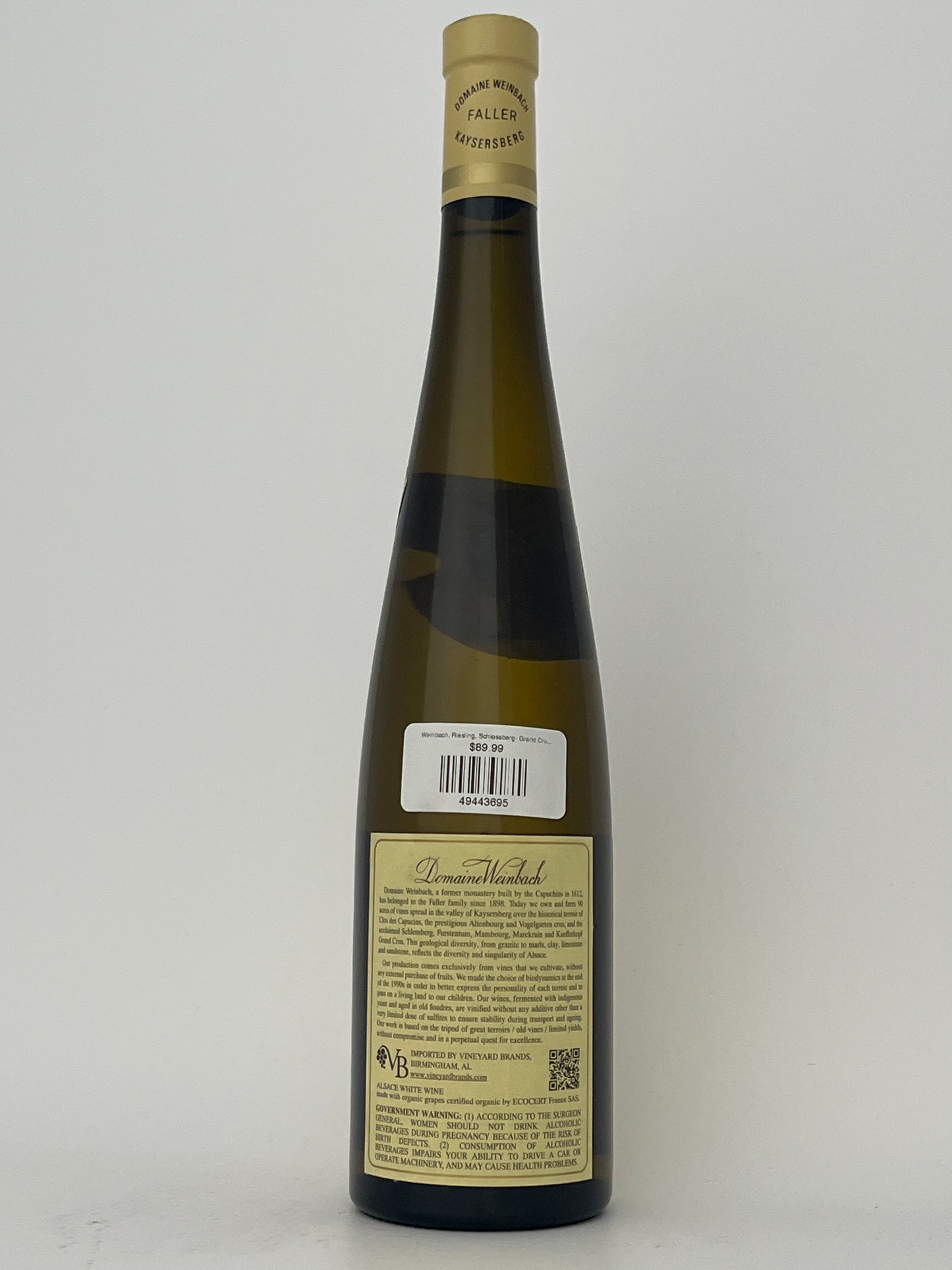 Back label of a bottle of Weinbach, Riesling, Schlossberg- Grand Cru, Alsace, France 2020 in a white backround.